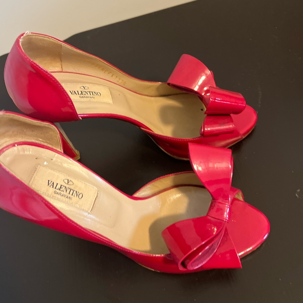 Valentino Garavani Hot Pink Patent Leather Bow D’Orsay pumps.